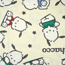 Cream colored t-shirt with a repeating pattern of Sanrio's Pochacco, in different colored shirts. Filler for the pattern are small stars and "Pochacco" written in neat cursive. Close up of the shirt.