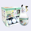 Display case with many egg shaped capsules containing a figure of Pochacco, a cartoon dog from Sanrio attached to a gold tone hardware keychain.