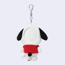 Plush keychain of a dog character wearing a red shirt on a white background. In the back of its head is a circular mirror.