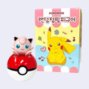 A Pokémon Jigglypuff toy sitting on top of a red and white Pokéball, shown next to its retail box featuring Pikachu artwork and Korean text.