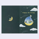 Birthday card with a cartoon bear on a moon-shaped boat, surrounded by clouds and stars,