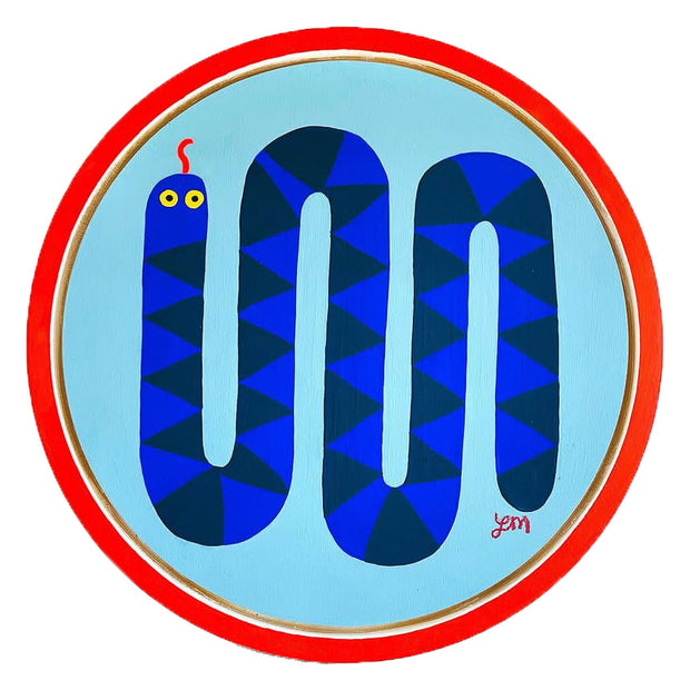 Painting of a blue, simply shaped snake with darker blue triangle pattern. It curves up and down, like multiple U shapes. It has yellow eyes and a red tongue extended out. The light blue circle panel is mounted in a red outer circle.