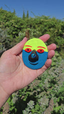 Video of mask being held in artist's hand.