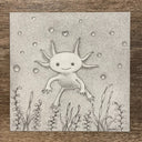 Graphite drawing of an axolotl, floating in water with bubbles and a heart shaped bubble directly above it. Sea weed frames the bottom of the piece.