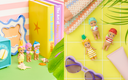 Colorful toys and items on a yellow surface with books and sunglasses.