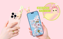 Smartphone with cherry blossom design held by a hand, decorated with small figurines on a pink background.
