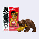 A PUNK DRUNKERS Aitsu Lucky Mascot figure shown next to its red and white retail box on a light gray background. The figure is a brown bear-like character holding a yellow fish, with the packaging featuring a man's face and Japanese text.