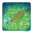 Colored pencil illustration of a lush green grass scene with a red and yellow garter snake slithering through. A small red head fairy hovers face to face with the snake.