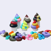 Several poo shaped erasers, designed with various colors and star and dot decorations. 