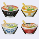 Four small instant ramen bowls arranged in a 2x2 grid on a light gray background. Each bowl has a different decorative rim design in black, yellow, blue, and red, with chopsticks resting inside the bowls.