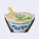 Small ceramic planter, shaped and designed to look like a ramen bowl with small wooden chopsticks poking out. Packaging encases the bowl, which has plant growing seeds and medium inside.