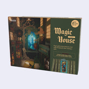 Product packaging of a 3D puzzle kit to build a bookend, scenery features a magical alleyway with small shops for wizards.