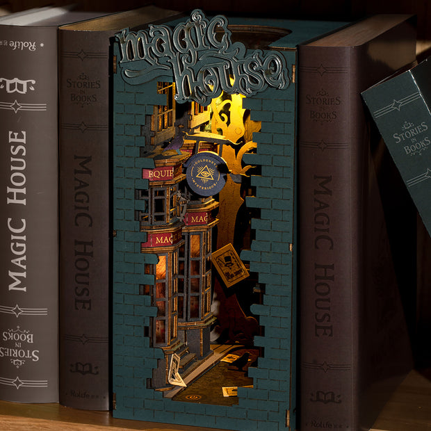 Display of Magic House book end installed between several books on a bookshelf.