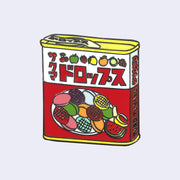 Die cut enamel pin of a tin of candy, Sakuma Drops, red and white packaging with drawings of fruit all over it. There is Japanese kanji written along the top and side of the container.