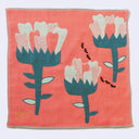 Salmon pink square handkerchief with 3 large stylistic white flowers with thick green stems, a small line of ants walks nearby.