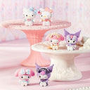 Cartoon character figurines on decorative stands with a soft pink background