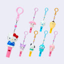 Set of colorful keychains of Sanrio Characters with whistles attached to their bodies.