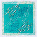 Teal fabric with white fish pattern on a white background