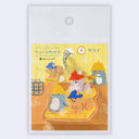 Acrylic keychain of a group of cartoon animals sitting on a bamboo mat in a sauna, wearing hats with steam clouds around them.