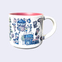 White ceramic mug with a metallic pink interior and various illustrations on it, all within a color scheme of blue, pink, white and green. Illustrations include a maneki, a boba, an exterior of a restaurant, a drip coffee machine, a store sign that says "Giant Robot Store" and a group of people walking under paper lanterns.