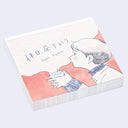 Memo pad with an illustration of a person holding a steamy cup of coffee and looking content.