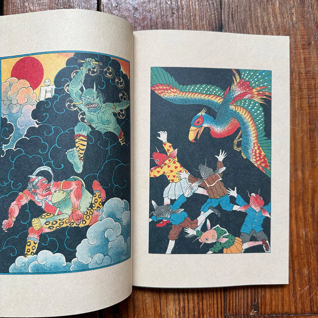 Open book displaying colorful illustrations of mythical creatures and characters on a wooden surface.