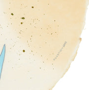 Paper circle with deckled edges and a soft orange and cream colored watercolor background. Blue and green fish with white bunny heads swim calmly. Close up of artist signature.