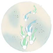 Paper circle with deckled edges and a soft blue and cream colored watercolor background. Blue and green fish with white bunny heads swim calmly.