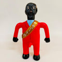 Toy figure in a red suit with a black face on a white background