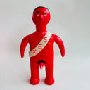 Red figurine with a white sash displaying 'SEX' on a light gray background