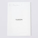 White sheet of paper with 'YUROOM' printed on a light gray background