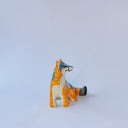 Small ceramic sculpture of an orange and blue-gray fox with carved poppy flower design.