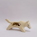 A cream colored ceramic wolf, with an opening in its body that holds gold charms, hanging from wire. Surrounded the opening are ceramic vine shapes.