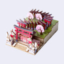 Model of a traditional Japanese shrine with cherry blossom trees on a light gray background