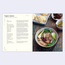 Bowl of vegan ramen with a recipe card on the left side.