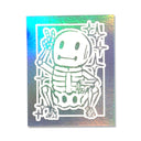 White ink sticker on holographic backing of a small cartoon skeleton, crouching and throwing up a peace sign.