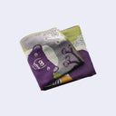 Folded fabric with animal design on a light purple background