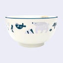 Off white bowl with purplish gray and blue colored illustrations of sea animals, such as otters, polar bears and fish.