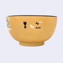 Yellow bowl with cream and brown colored illustrations of a small bird and forest greenery (flowers, grass, butterflies)