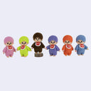 Set of colorful flocked mini Monchhichi figures with different colored hair, standing in a row.