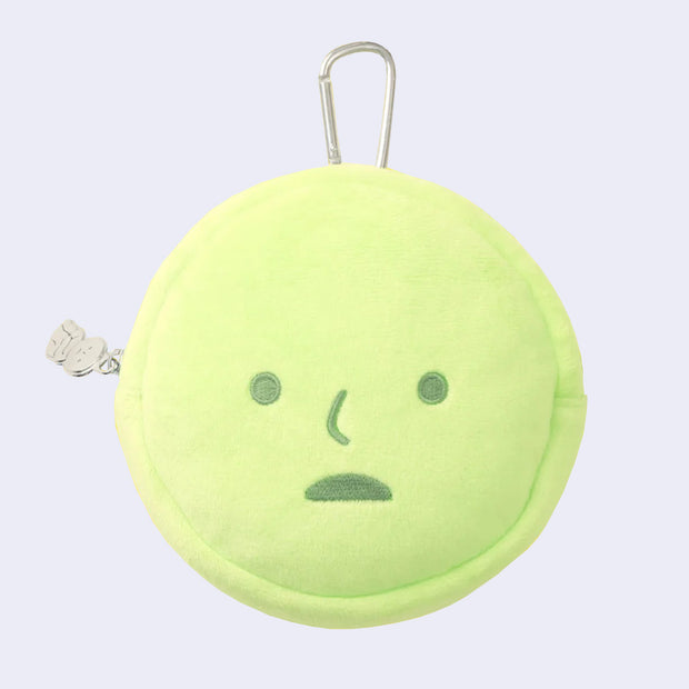 Green, circular plush pouch shaped like Smiski's head with a somewhat surprised expression. Attached is a silver carabiner and a small zipper charm of Smiski sitting.