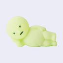 Light green cartoon-like creature, laying on its side with its hand propping up its head. 
