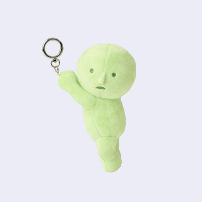 Plush keychain of a Smiski, dangling from a keyring.