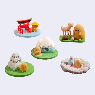 5 different designs of a potato character, Tayto, during different scene of popular Japanese tourist spots. Options are Tayto at Torii Gates, Tayto with Nara Deer, Tayto with Mt. Fuji, Tayto at a temple and Tayto with hot spring monkeys.