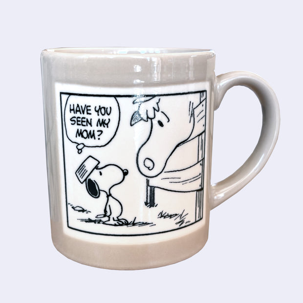Mug with a cartoon design of a Snoopy looking up at a horse and asking 'Have you seen my mom?'