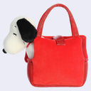 A red plush tote bag with a Snoopy plush toy peeking out from the side pocket, set against a plain light gray background.