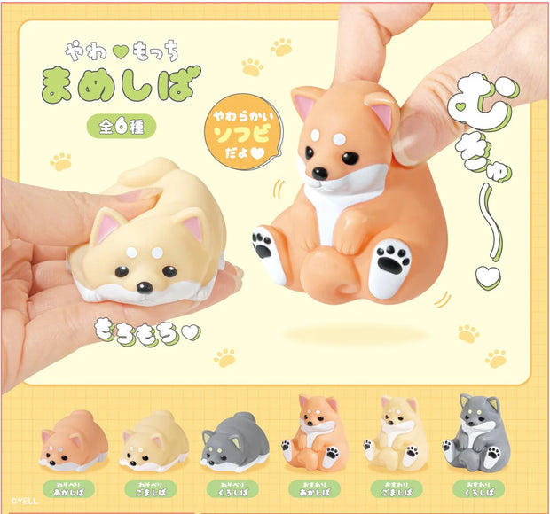 Set of small animal figurines held by hands with a yellow background