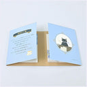 An open sticky note set with light blue inserts, featuring Japanese text on one side and an illustration of a black cat in an oval frame on the other, displayed against a plain white background.