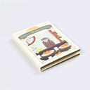 A booklet of sticky notes, shown from the side, closed. The cream-colored cover features an illustration of an owl in a kitchen and the product name 'Shell Madelesins' in green lettering.