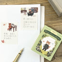 Notebook with cute illustrations, a pen, and a book titled 'Ressa Panda Books' on a wooden surface.